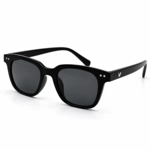 Angled view of matte black square-frame sunglass with dark lenses and paired silver dot rivets on the front corners.